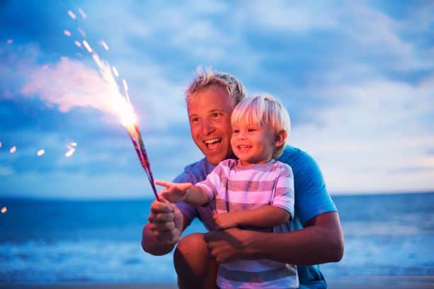 Father and son with fireworks