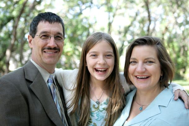 smiling family of three