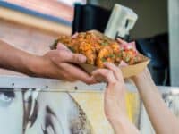 food truck window handing out basket of wings