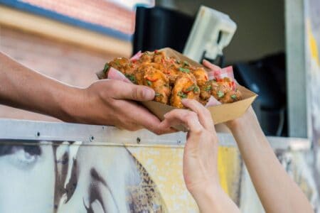 food truck window handing out basket of wings