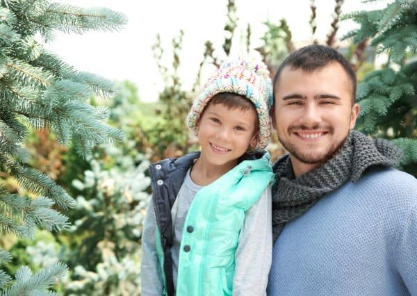 father and son at a christmas tree farm