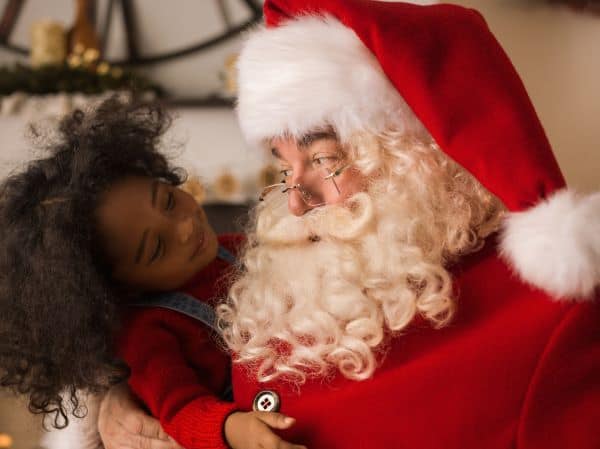 young girl talking with Santa Claus