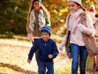 family walking a trail in fall or winter