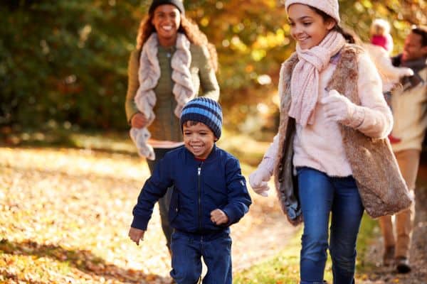 family walking a trail in fall or winter