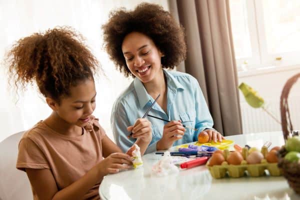 mother and daughter coloring easter eggs