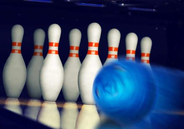 bowling ball about to strike bowling pins