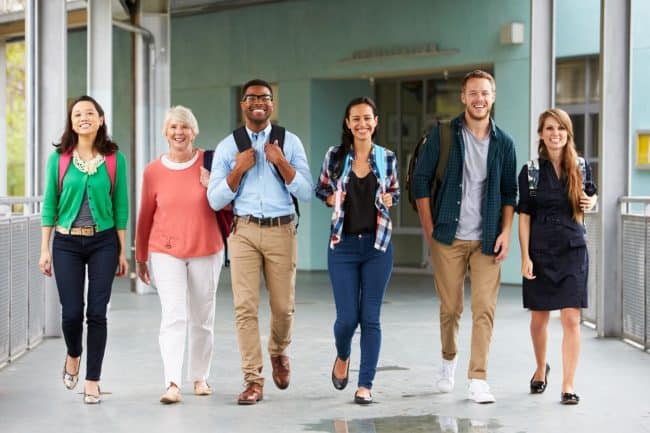 group of teachers in school corridor