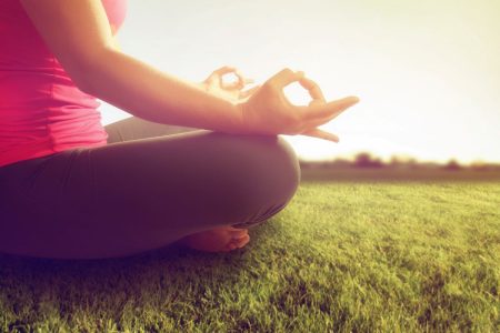 woman practicing yoga outdoors
