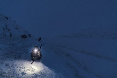 "Scale of Hope" adventure film image on a snowmobile at night