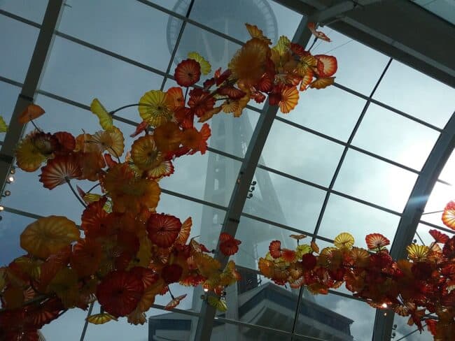 Glass sculpture at Chihuly Museum with fog shrouded Space Needle in background