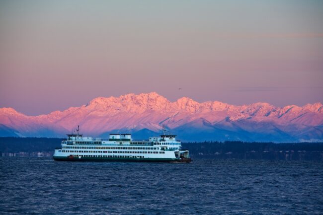 Washington State Ferry crossing Puget Sound in winter with dawn alpenglow
